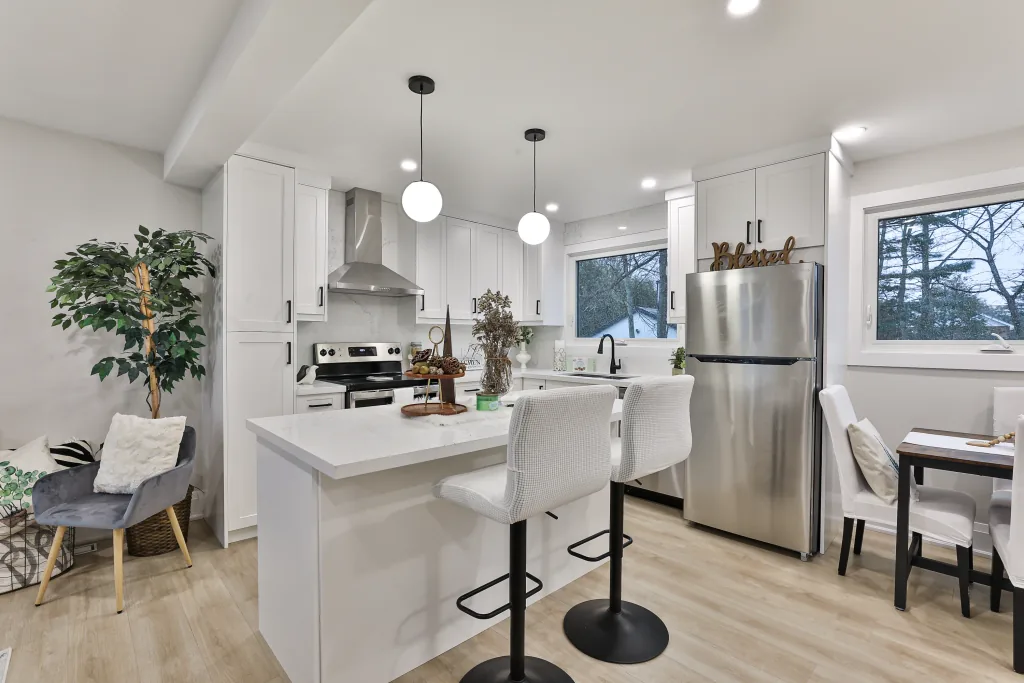 Kitchen repainting by Sigma Painting — white shaker cabinetry and island in a refreshed kitchen
