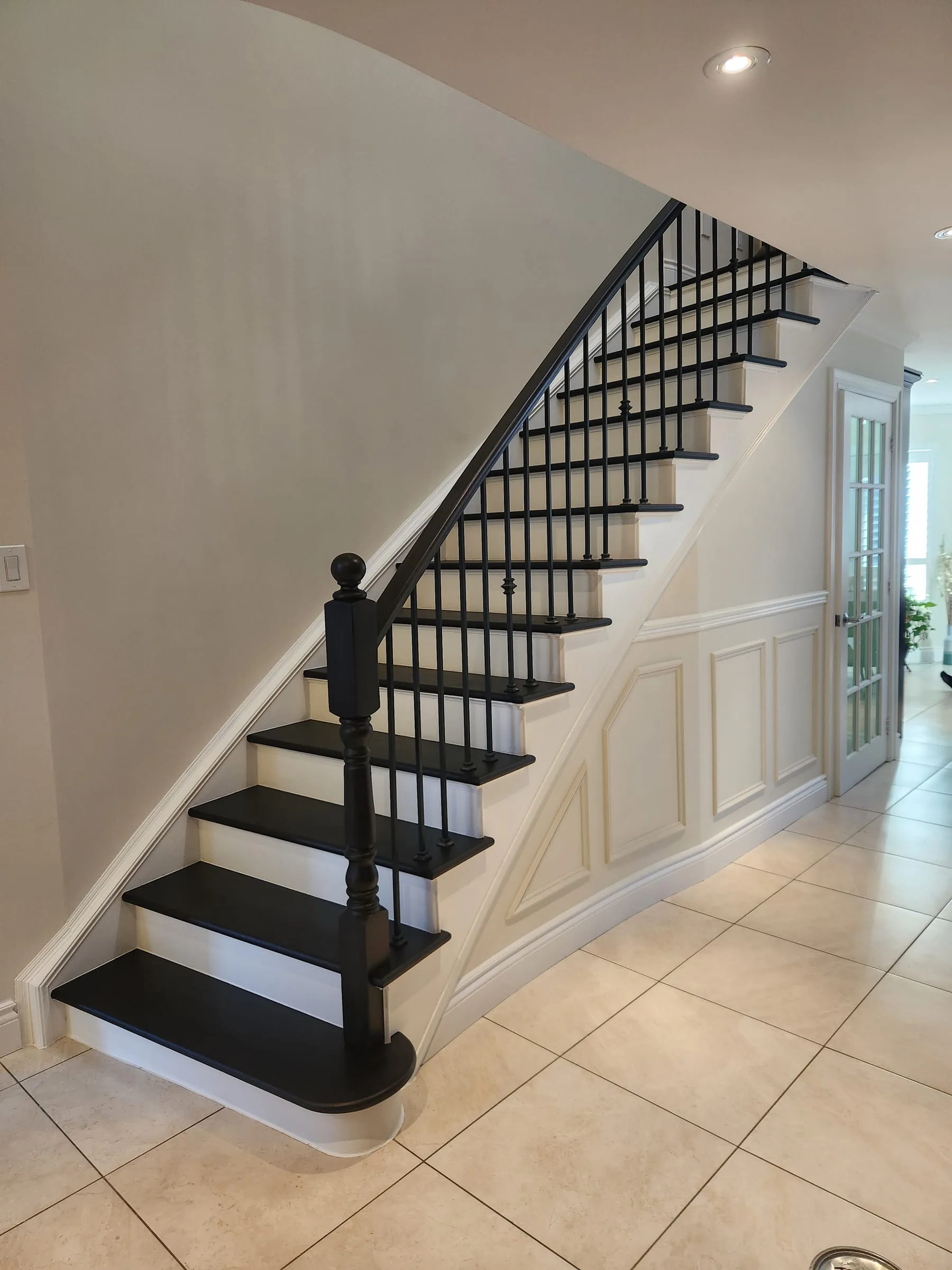 After — dark-stained, refinished hardwood staircase by Sigma Painting