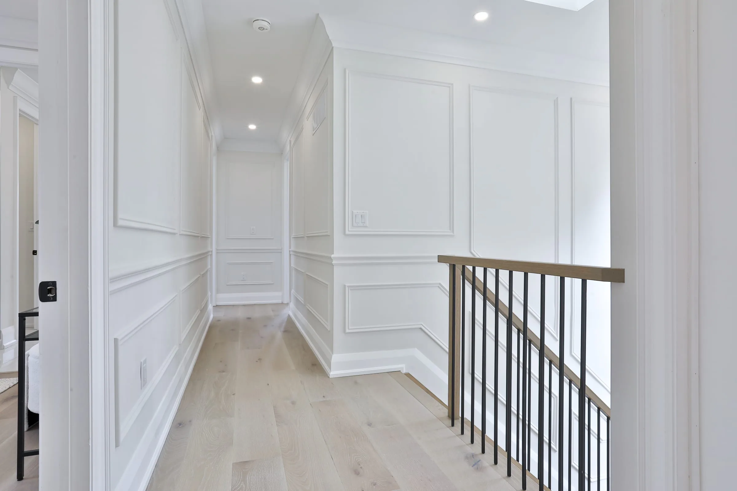 Sigma Painting — luxury interior hallway with crisp white wainscoting and trim