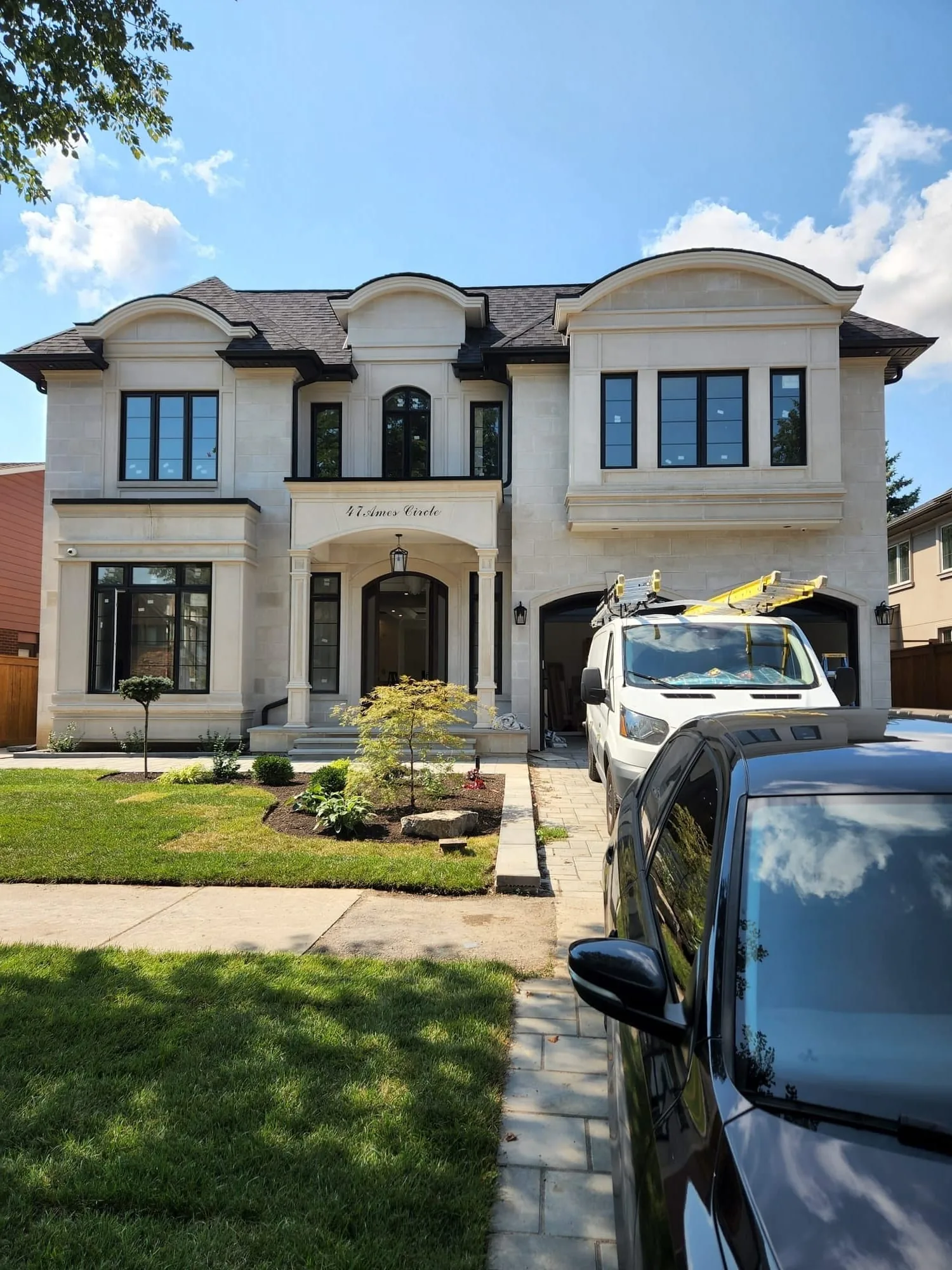 Exterior painting by Sigma Painting — limestone estate home with black window trim in North York