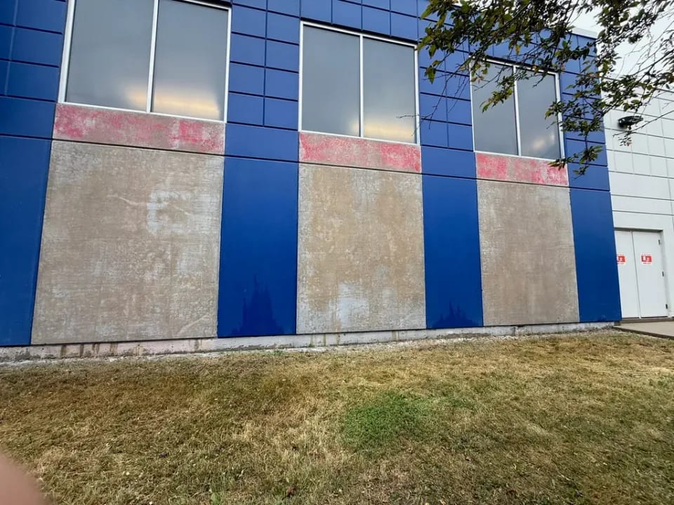 Exposed concrete panels after coating removal at a Walmart restoration by Sigma Painting in the Greater Toronto Area