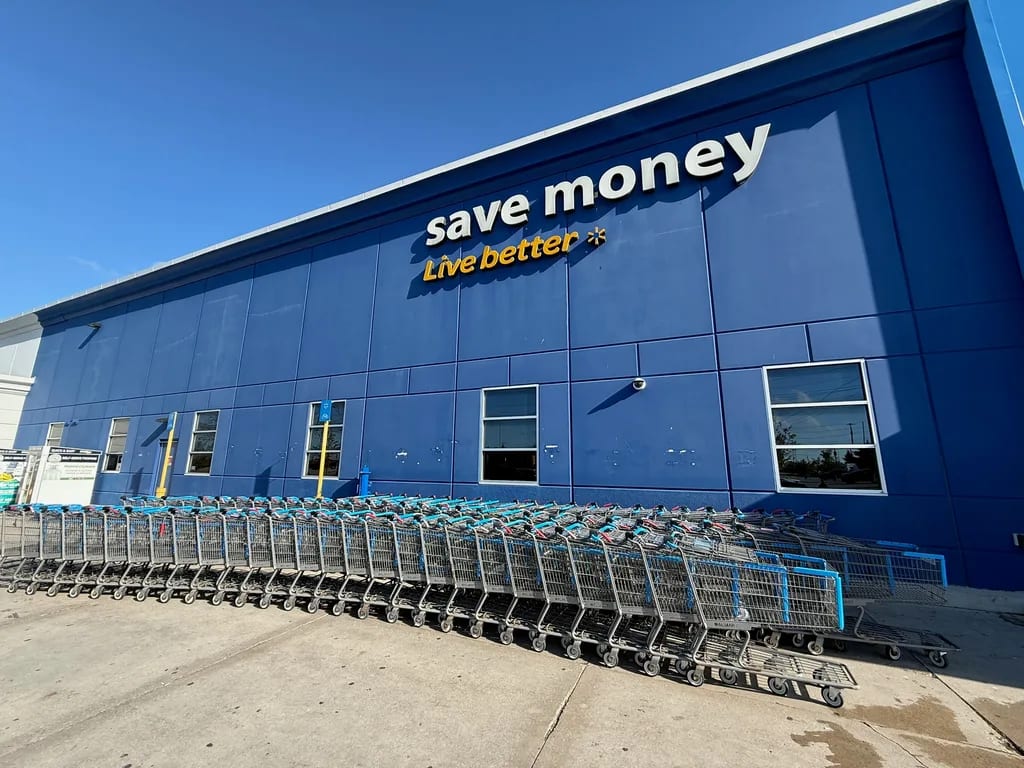 Peeling blue paint on a Walmart storefront before concrete coating restoration by Sigma Painting in the Greater Toronto Area