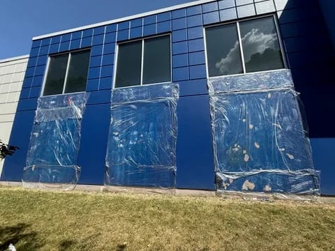 Paint stripper held under plastic on Walmart concrete wall panels during restoration by Sigma Painting in the Greater Toronto Area